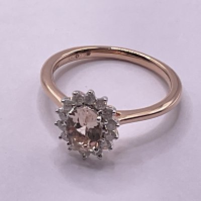 9ct rose gold cluster ring set with a central oval cut morganite and surrounding diamonds. Morganite 0.80ct. Diamonds 0.25ct. Ring size approx N. Postage category A.