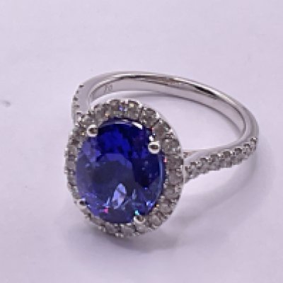 Certified platinum ring set with an oval tanzanite surrounded by RBC diamonds with RBC diamond set shoulders. Tanzanite 4.51ct. Diamonds 0.76ct / G-H cert no. WGI9634157939. Ring size approx O. Postage category A.