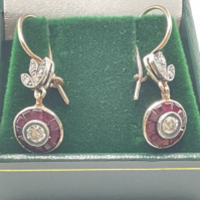 Pair of 8ct rose gold fish hook target style drop earrings set with R/C diamonds surrounded by calibre cut rubies, with further diamonds in the bales, boxed. Rubies 0.58ct approx. Diamonds 0.60ct approx. Postage category A.