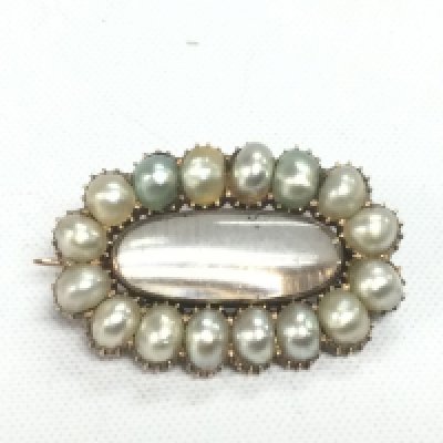 A mourning brooch set with pearls. Shipping category A.
