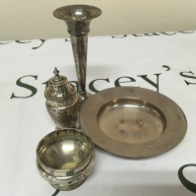 A small silver dish condiments and a small , silver vase.