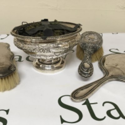 A silver rose bowl silver backed mirror and two silver brushes.