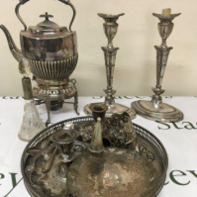 A silver plated spirit kettle a pair of Neo-classical silver plated candle sticks other plated items and some silver.