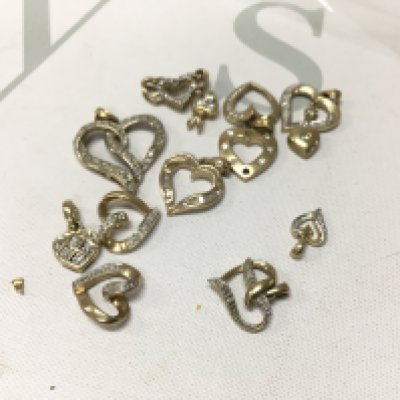 A small collection of 9ct gold diamond set heart pendants. Approx weight 12.2 grams.