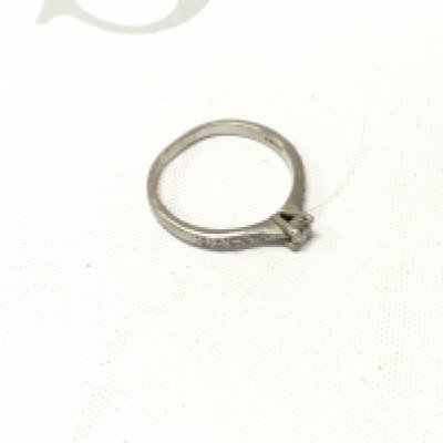 A platinum diamond solitaire ring with stone set shoulders. Approx weight 3.1 grams, Approx size N.