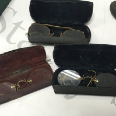 Four cased spectacles.