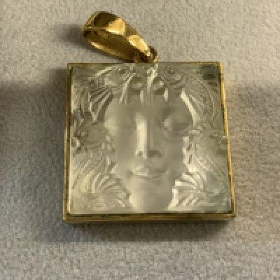 LALIQUE "MASQUE DE FEMME" CRYSTAL PENDANT & EARRINGS Mid-20th Century Raised woman's face surrounded by Ocean Life, mounted on a gold-plated 1.25" square. Marked "Lalique" and stamped on reverse.