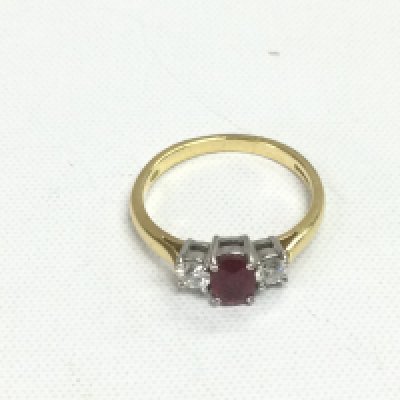An 18ct gold, ruby and diamond three stone ring, VS2 G/H. Approx 2.6g and approx size J-K. Shipping category A.