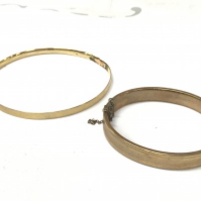 Two gold tone bangles . Postage category A
