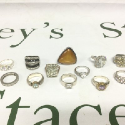 Twelve silver and white metal rings set with stones. Shipping category A.