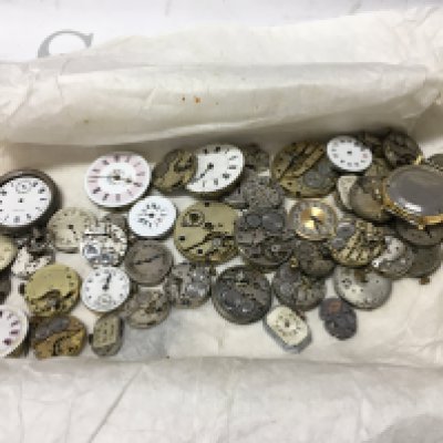 A mixed collection of vintage watch movements for spares . Postage cat b
