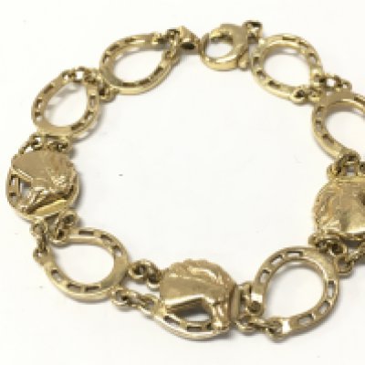A 9ct gold horse shoe bracelet , 13.6g total weight. Postage category A