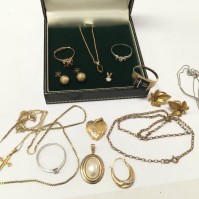A collection of 9ct gold including rings, pendants, necklaces one set with a ruby pendant etc. total approximately 28g. postage category A