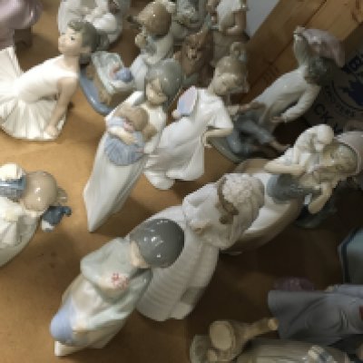 A collection of Nao figures including Pillow Fight, girl with doll and boy with puppy