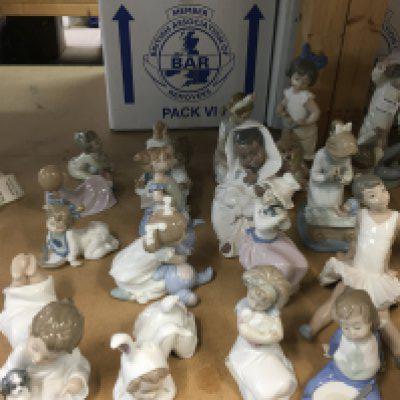 A collection of Nao child figures including ballet girl, child with puppy and book, child with rabbit teddy etc