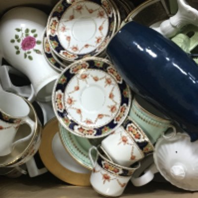 A box containing decorative Victorian and later cups and saucers and other ceramics.