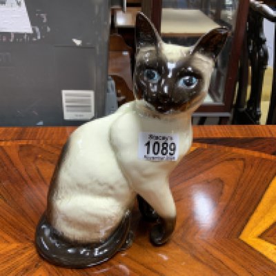 A Beswick cat ornament. Postage category D.