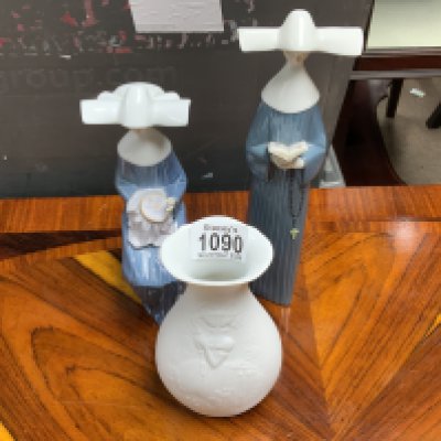 Two Lladro figures and a Kaiser porcelain bottle vase. Postage category D.