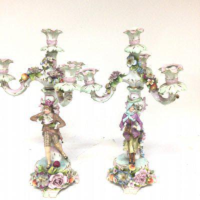 A pair of late 19th century porcelain candelabra with raised flowers and foliage surmounted with figures with scroll branches height 39cm