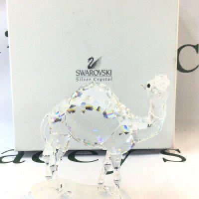 A boxed Swarovski Crystal glass camel figure. Approximately 11cm tall. No obvious damage or restoration Postage category B