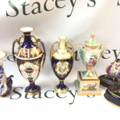 A collection of vases including Royal Crown Derby, Coalport twin handled vase decorated with painted nature scenes , Royal Doulton Iris vase & House of Erte Franklin Mint figures, 12 to 23cm tall. Some damage