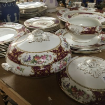 A part dinner service with a patterned boarder retailed by Waring & Gillow