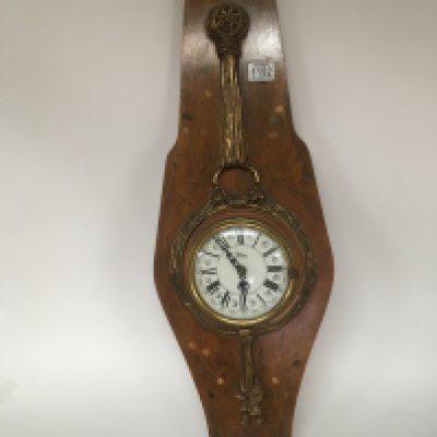 A 20th century key wind wall clock with applied ornate brass embellishment on a walnut marquetry panel. Height 90cm