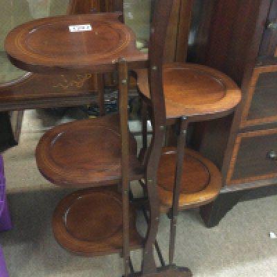 A Edwardian mahogany cake stand with five tiers .