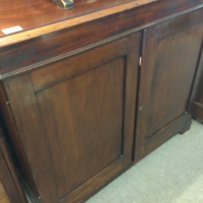A small Edwardian mahogany cupboard with two doors on bracket Feet .