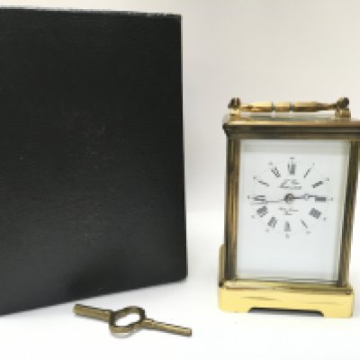 A boxed L Epee French brass carriage clock with decorated with ceramic side panels. Including key, seen working. Postage category B