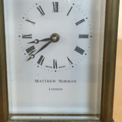 A brass case Carriage clock the dial with Roman numerals, Matthew Norman London.