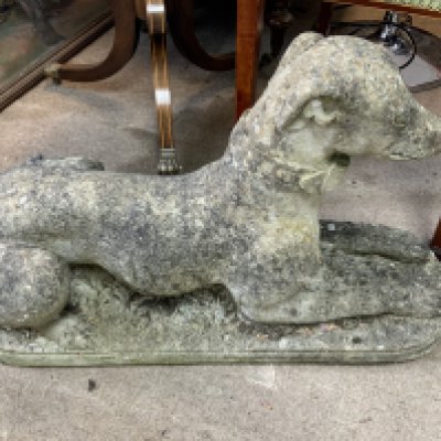 A composite stone figure of a greyhound. 64cm. (D)