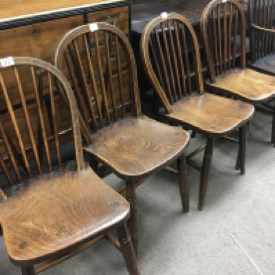 A set of four elm stick back chairs with military stamped together with two stick back chairs .