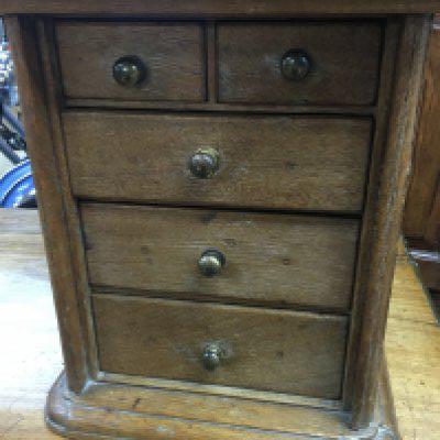 A small oak collector&rsquo;s cabinet fitted with five drawers.