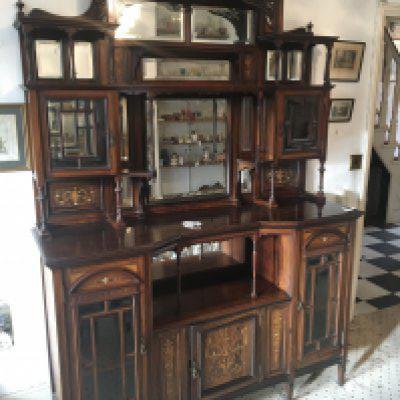 A fine quality Edwardian inlaid Rosewood chiffonier the raised back with mirrors and bevel edge glazed doors with an open section and further cupboards very good condition. Height 225cm width 155cm