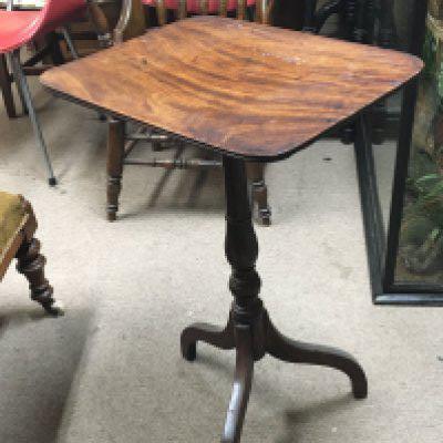A George III mahogany occasional table with a hinged top on a turned column and splayed legs.