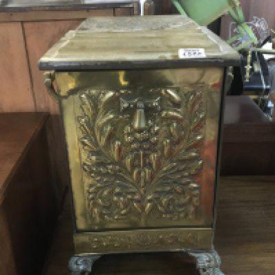 A Victorian brass coal box with a pressed elaborate decoration.