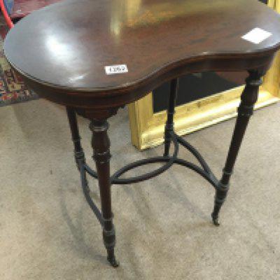 A Quality Edwardian occasional table the centre inlaid with musical instruments and foliage. On turned legs united by stretches.