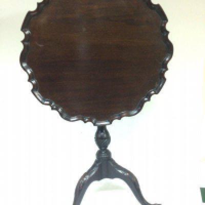 A George III possibly Irish carved Mahogany occasional table the tip action top with a shaped edge on a spiral column with a ring of repeat pattern flowers the cabriole legs with carved knuckles terminating in ball and claw feet. Top diamter 57cm 69cm high no obvious condition issues.