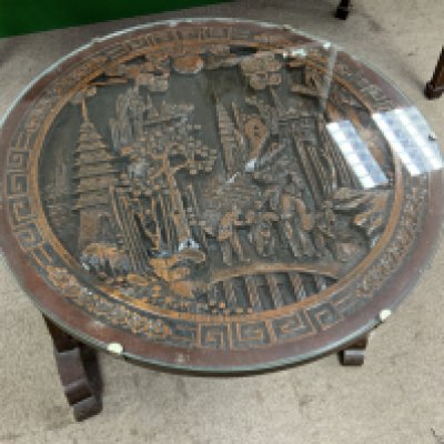 A 1950s Oriental carved top folding occasional table.