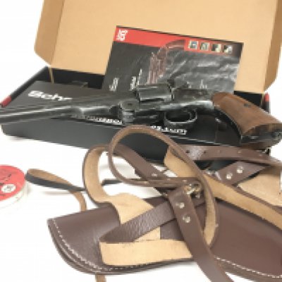 A Schofield 6 inch aged black CO2 .177 revolver. Comes in original box with reloadable cartridges, pellets and leather holster