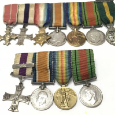 A Collection of miniature British WW1 & 2 medals including a military cross, order of the British empire, territorial efficiency division. Postage category A