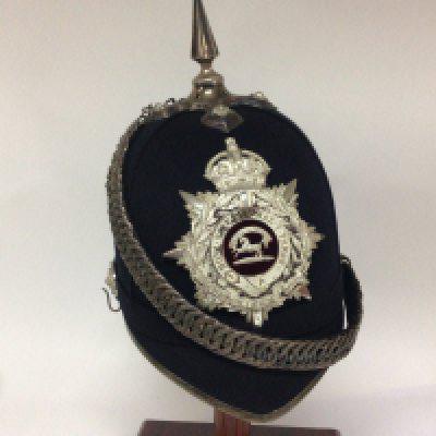 A Military bandsmen hat black with applied badge for The Kings Regiment.