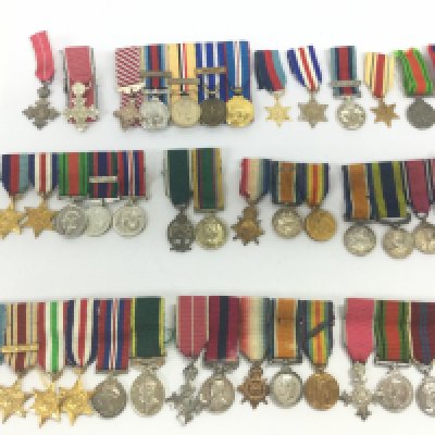 A collection of miniature British war medals including Order of the British Empire, distinguished conduct one with India bar, Normandy Campaign. Postage category B