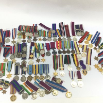 A collection of miniature British and other war medals including South Africa campaign medal, Bravery in the field, various stars etc. postage cat B