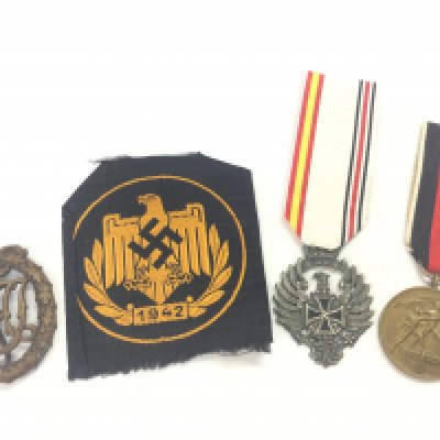 A collection of Third Reich items including a Sports eagle cloth badge, Sudentenland 1938 medal, DRL sports badge, Medal of the Spanish Blue Division Russia Service. Postage category A