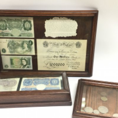 A collection of framed British coins and bank notes including one pound notes, Ten Shillings. This lot cannot be posted