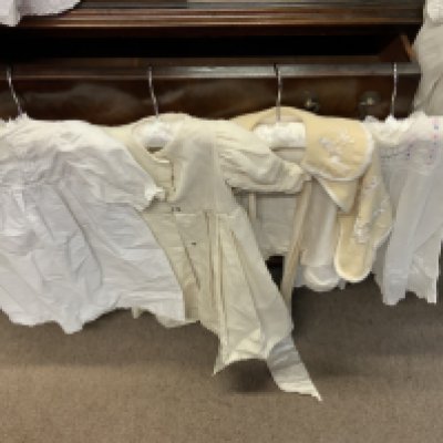 A good collection of Edwardian through to 1930s linen and lace christening gowns, dresses and outfits. (C)