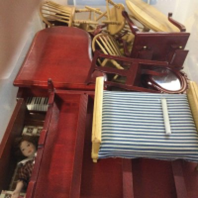 A box containing dolls house furniture.