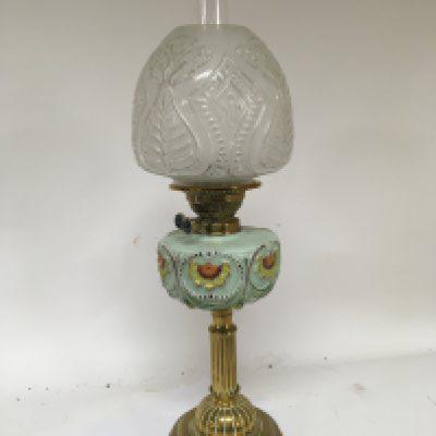 A Victorian coloured glass and brass oil lamp with a glass shade and chimney.height 65cm